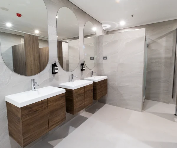 Modern hotel bathroom renovation in Perth with custom vanities and upgraded finishes by Your Trade Solutions