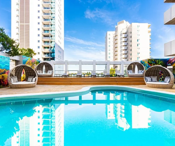 Hotel pool area in Perth after composite decking installation creating a modern resort style poolside space by Your Trade Solutions