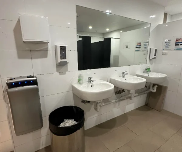 Commercial hotel bathroom before renovation in Perth with basic fixtures prior to upgrade by Your Trade Solutions