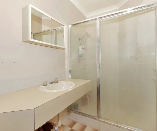 Bathroom before renovation in Perth showing original vanity and shower prior to full home upgrade by Your Trade Solutions